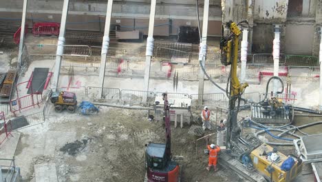 HIGH-ANGLE-view-of-construction-work-taking-place-using-pile-driver-machine
