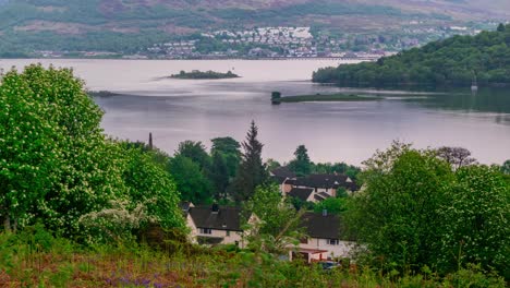 Cinematic-timelapse-of-scottish-lake-sunset-during-golden-hour-with-lake-village-in-background