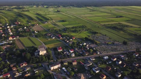 Aerial-view-with-tilt-up-of-a-little-town-in-the-countryside-of-Poland-during-the-sunset