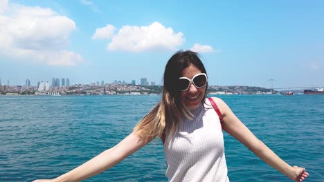 Slow-motion:beautiful-girl-turns-around-in-front-of-Bosphorus,a-popular-destination-in-Istanbul,Turkey