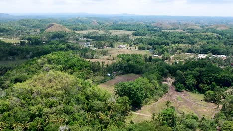 Aerial-view-of-landscape-around-the-Chocolate-Hills-viewing-complex,-Bohol,-Philippines