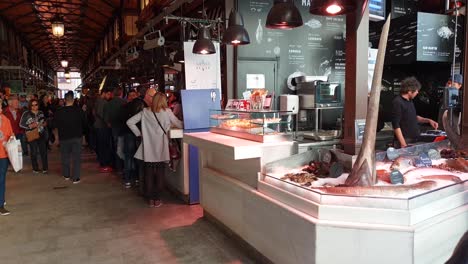 Tourists-enjoying-Charcuteria-jamones-at-Mercado-de-San-Miguel-in-Madrid