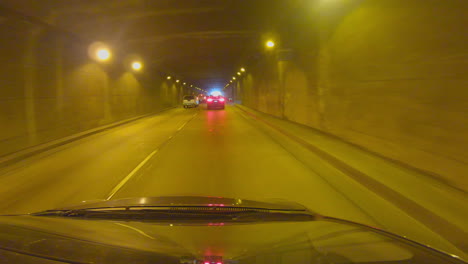 Car-drives-through-a-lighted-tunnel