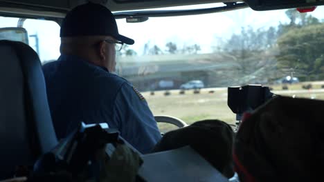 Firefighter-drives-a-fire-truck-on-public-roads-viewed-from-inside-cab