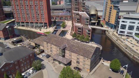Left-to-Right-Pan-of-Granary-Wharf-in-Leeds,-UK-on-a-Sunny-Summer’s-Day-from-a-High-Vantage-Point-with-Canal---Pub-Garden-Visible