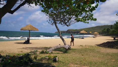 Una-Playa-De-Arena-Blanca-Para-Relajarse-En-La-Isla-Caribeña-De-Granada-Con-Personas-Jugando-En-La-Arena