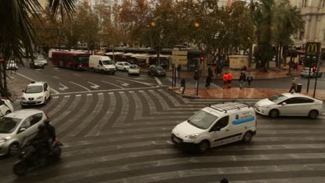 Fast-time-Lapse-of-busy-European-city-intersection-during-gloomy-autumn-with-congestion-and-many-pedestrians