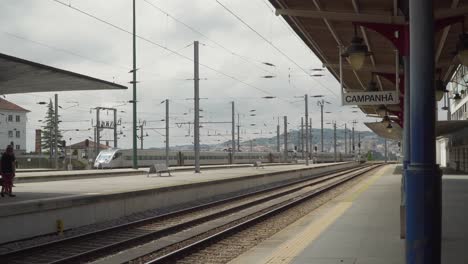 Gray,-long-train-leaving-Campanhã-train-station-in-Porto,-Portugal