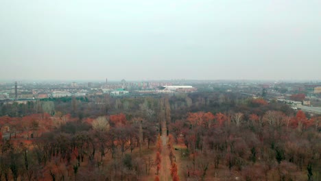 Budapest,-Hungary,-Flying-over-Kerepesi-Cemetery-by-Drone-in-autumn,-golden-and-brown-leaves,-hazy,-foggy-weather,-Ferenc-Deák-Mausoleum---tomb