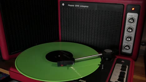 Old-Vinyl-record-player-spinning-a-new-green-Billie-Eilish-record