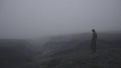 Silhouette-in-abandoned-icelandic-canyon-in-a-foggy,-moody,-dramatic-landscape