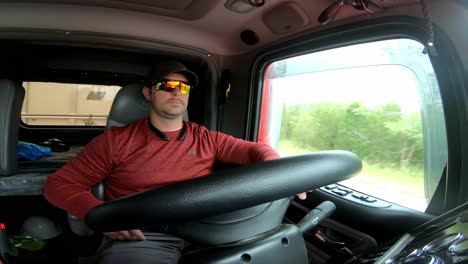 Truck-driver-hauls-heavy-load-down-interstate-highway