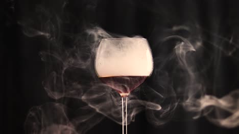 Glass-filled-with-cola-and-smoke-with-a-black-background-warm-temperature