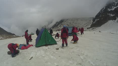 Tent-pitching-by-Himalayan-mountaineers-for-their-stay-in-upper-Himalayas-snowy-peaks