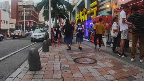 People-walking-down-sidewalk-in-popular-tourist-shopping-strip-Kokusai-dori