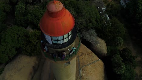 Light-house-of-mamallapuram-situated-among-famous-Rock-cut-Pallava-era-temples,-aerial-view-shot-on-Phantom-4-pro-4K-drone