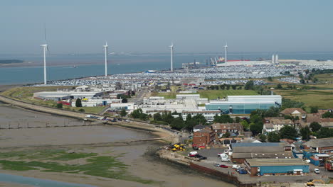 Wide-aerial-view-of-Sheerness-Docks,-with-a-reveal-of-the-fishing-village-of-Queenborough-on-the-Isle-Of-Sheppey,-Kent,-UK