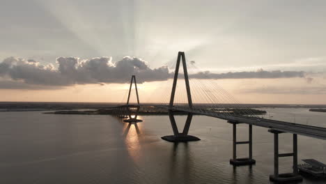 Aerial-pan-across-Ravenel-Bridge-in-Charleston,-South-Carolina,-USA-at-sunset-with-light-traffic