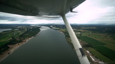 Schöne-Aufnahmen-Aus-Dem-Fenster-Eines-Kleinen-Flugzeugs,-Das-An-Einem-Bewölkten-Tag-über-Den-Columbia-River-Fliegt
