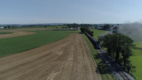 Aerial-View-of-a-Thomas-the-Tank-Engine-with-Passenger-Cars-Puffing-along-Amish-Countryside