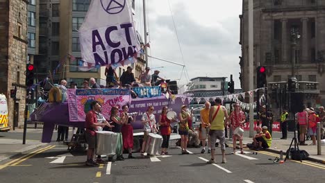 Slow-motion-of-Extinction-Rebellion-protesters-playing-music-in-front-of-a-small-crowd