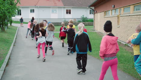 Elementary-class-mates-running-on-the-school-grounds,-slow-motion