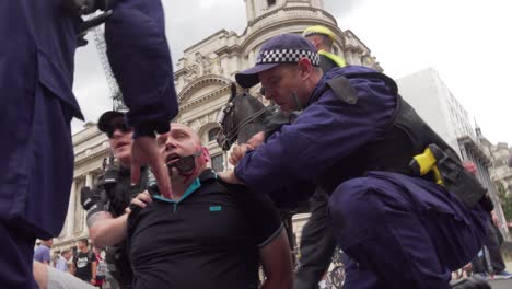 A-Tommy-Robinson-supporter-is-arrested-by-police-along-Whitehall,-London