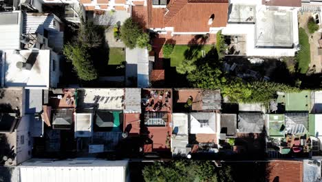 Aerial-view-of-rooftop-in-the-city-of-Montevideo-Uruguay-with-people-and-friends-having-a-barbecue-and-playing-football-on-a-sunny-day
