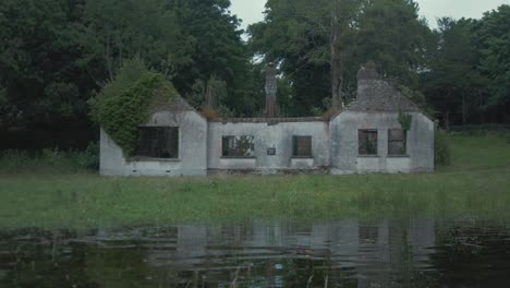 Derelict-bungalow-house-sits-on-river-shoreline