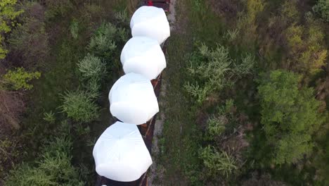 Wind-Turbine-Nacelle-And-Hub-Ready-For-Transporting-On-The-Train-In-Monroe,-Michigan---top-down-drone-shot