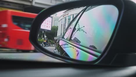 Close-up-of-side-mirror-of-car-during-rush-hour-time-at-intersection-in-Kuala-Lumpur