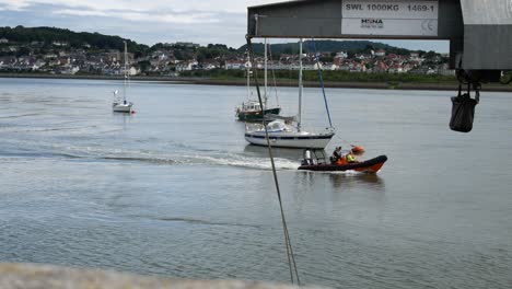 Coastal-Conwy-town-fishing-boat-returning-to-North-Wales-tourist-destination-scenic-harbour