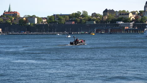 Stockholm,-Sweden,-Boat-With-Passengers-Sailing-in-Riddarfjarden-Bay-of-Baltic-Sea,-Old-Town-in-Background,-50fps