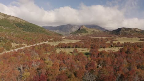 Aerial-shot-of-a-spectacular-mountain-and-autumnal-forest-landscape-near-Bariloche,-Argentina
