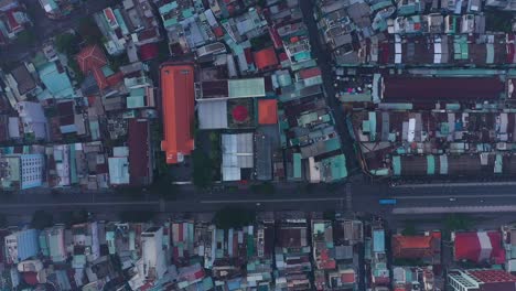 early-morning-top-down-drone-view-of-street-and-rooftops-in-a-busy-and-densely-populated-area-featuring-main-road-and-church-building
