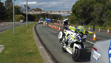 Police-Motorcycle-Parked-Behind-The-Police-Car---Police-Checkpoint-At-NSW---QLD-State-Border---Pandemic-Coronavirus-Restrictions-In-Australia