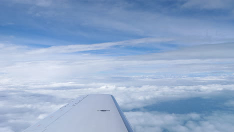 Passenger-POV-of-Airplane-Wing-and-Majestic-Cloudscape