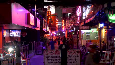 Entrance-of-Soi-Cowboy,-security-guard-standing-at-the-Red-Light-District