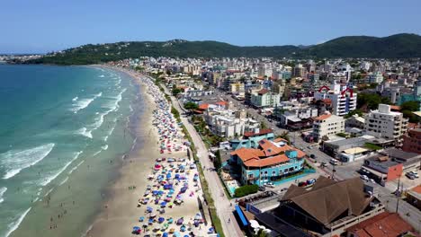 Aerial-establishing-shot-of-Bombinhas-beach-on-a-sunny-day-in-Brazil