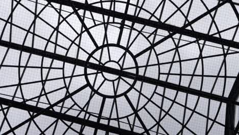 Looking-up-at-geometric-style-glass-ceiling-rotating-shot