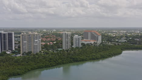 North-Naples-Florida-Aerial-v12-pan-right-shot-of-park,-Pelican-Bay,-shore-and-Gulf-of-Mexico---March-2020