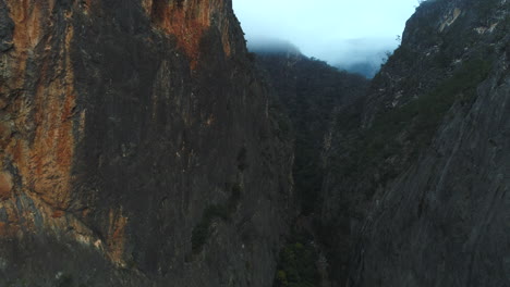 Aerial-view-of-drone-flying-through-the-a-large-gorge-on-a-cold-foggy-winter-day-in-the-Bungonia-National-Park-NSW-Australia