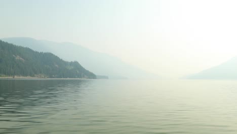 Skimming-over-the-lake-on-a-motor-boat-during-a-really-smokey-day-from-forest-fires