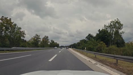 Hyperlapse-of-a-cars-front-view-drive-and-change-the-lane-of-two-different-motorways-with-some-traffic-on-the-street