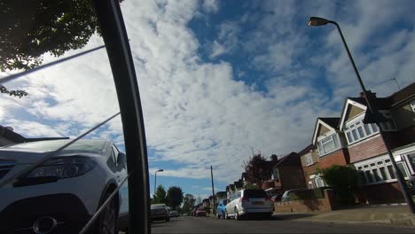Low-Angle-POV-From-Front-Wheel-Cycling-Past-Runners-On-Street