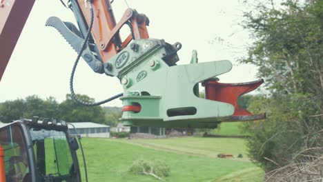 Tree-shears-on-digger-excavator-lifting-up