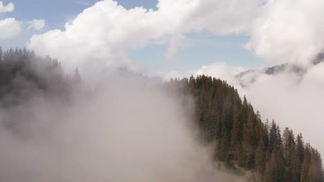 Aerial-of-mountain-top-surrounded-by-clouds