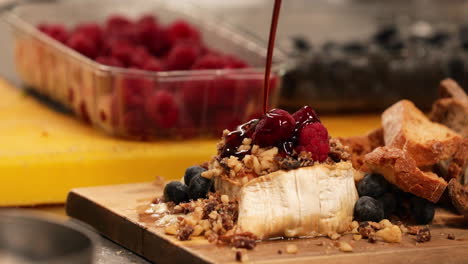 Dripping-Raspberry-Sauce-Over-Bread-With-Mixed-Berries-And-Nuts