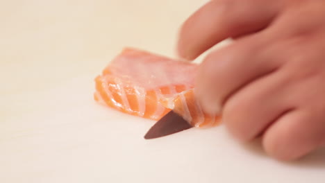 Slicing-Fresh-Salmon-Meat-For-Sushi---close-up