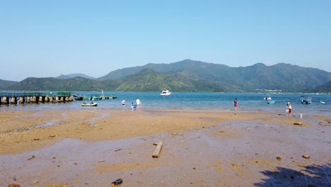 Locals-in-Hong-Kong-pebbles-beach-in-Wu-Kai-Sha-area,-Aerial-view